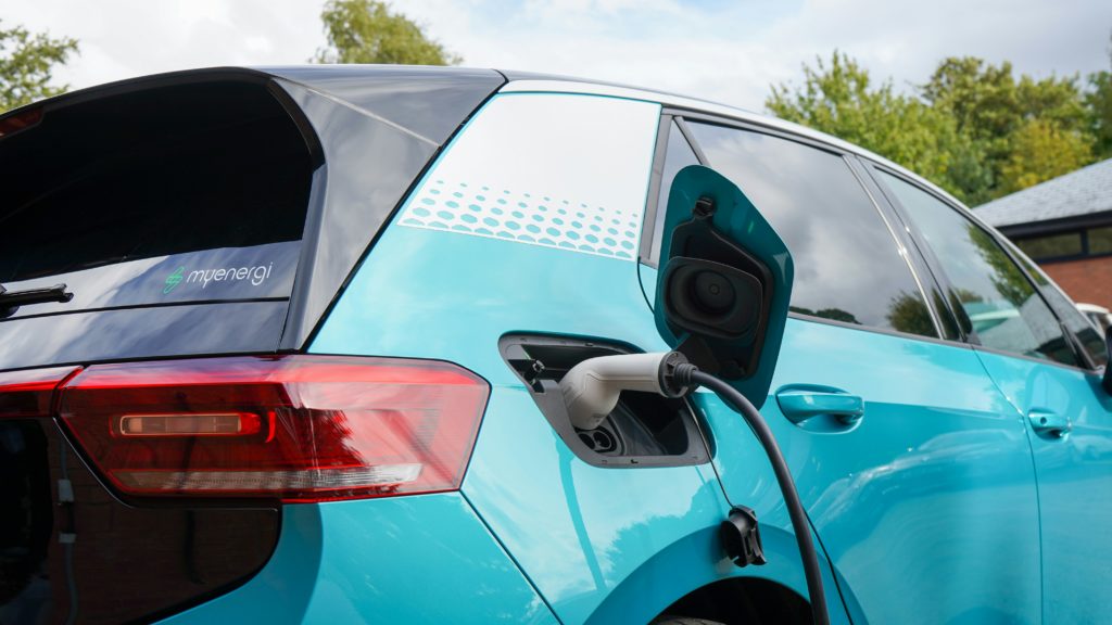 Blue electric car being charged