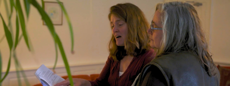 An assessor talks through data points on an energy reduction report.